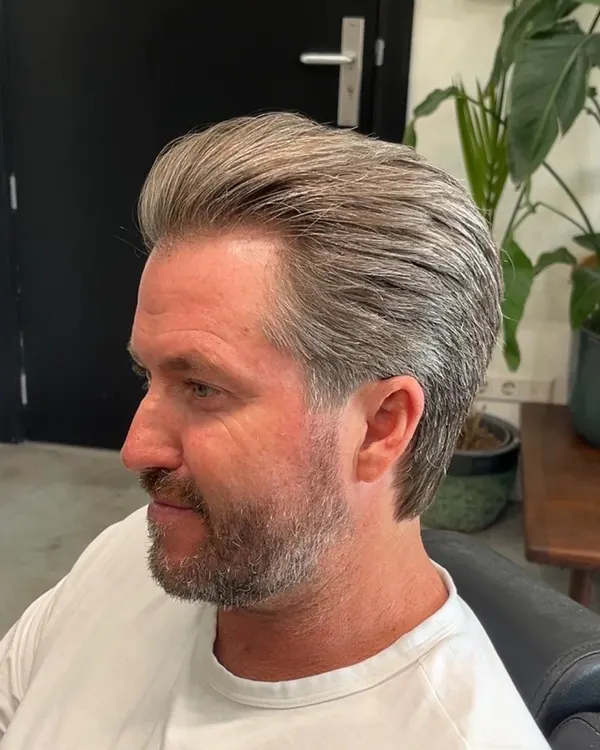 Grey swept-back cut with a trimmed beard