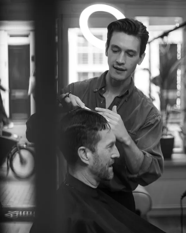 Ryan at work through the shop doorway, black and white